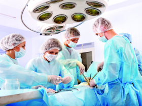 bigstock-Team-surgeon-at-work-in-operat-34312280